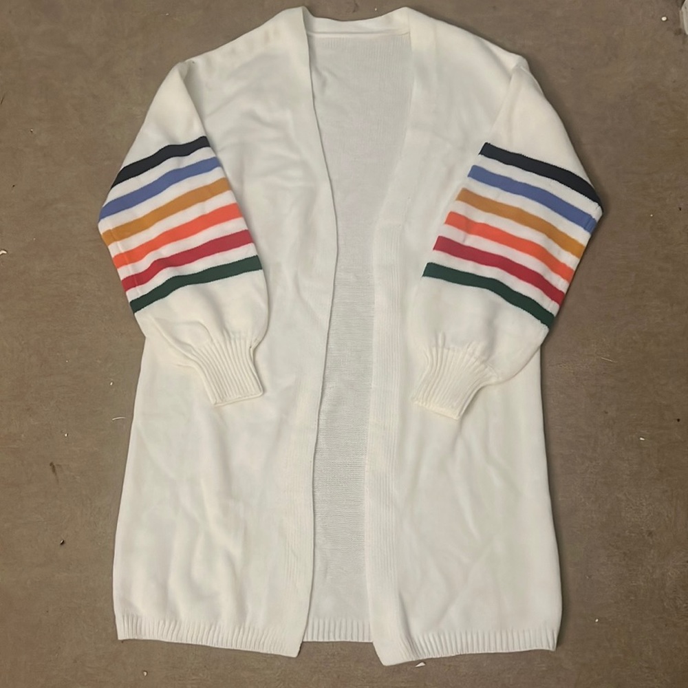 white cardigan with rainbow sleeves